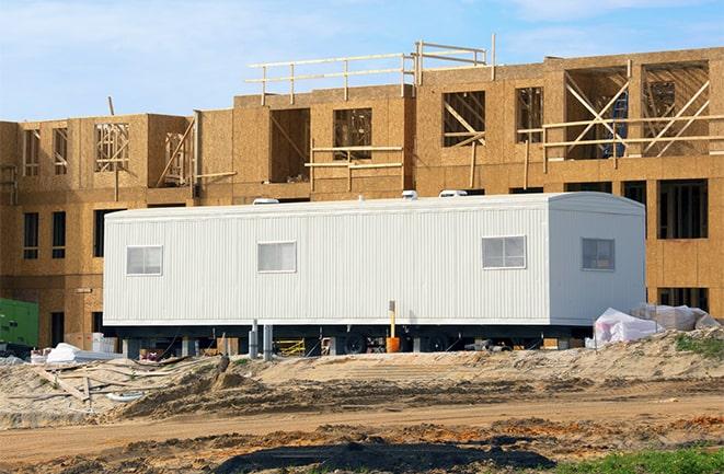 crane lifting modular building for construction office rentals in Middlefield